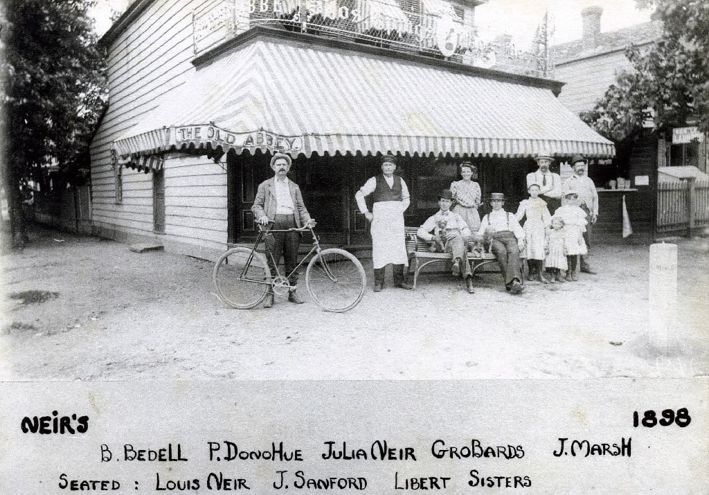 People outside Neir’s Tavern beneath The Old Abbey awning in an 1898 photograph