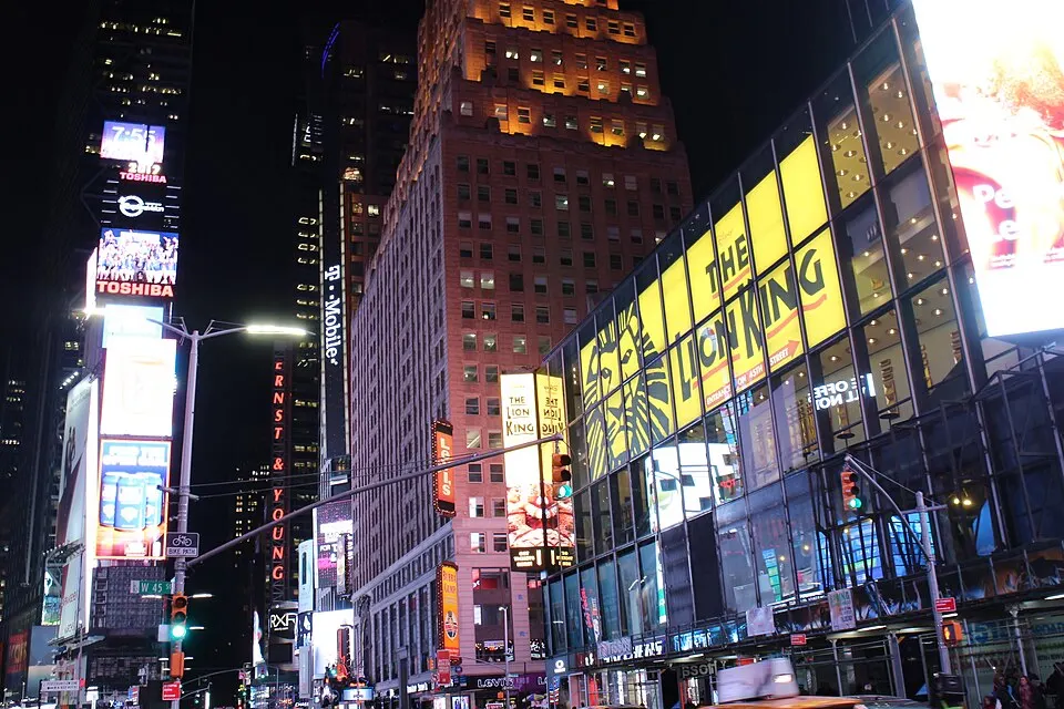 Illuminated theater signs and billboards in Times Square at night